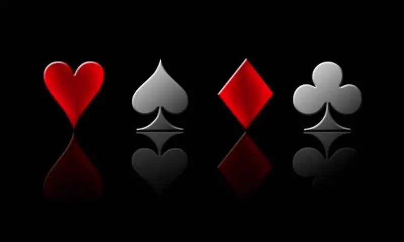 Heart, spade, diamond and club symbols in red and silver reflected on a black surface